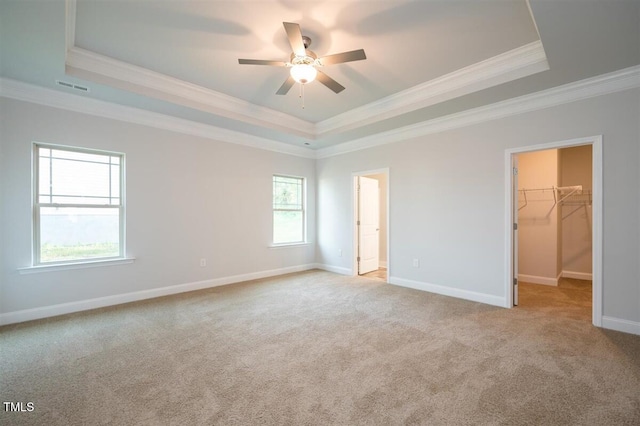 120 Newport Lndg Unit 99, Garner, NC 27529 - unfurnished bedroom featuring a raised ceiling, ornamental molding, carpet flooring, a spacious closet, and baseboards