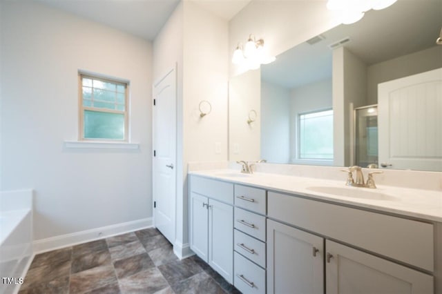 120 Newport Lndg Unit 99, Garner, NC 27529 - full bath with double vanity, healthy amount of natural light, baseboards, and a garden tub