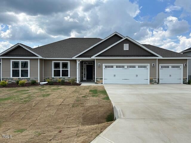 120 Newport Lndg Unit 99, Garner, NC 27529 - craftsman-style home featuring stone siding, an attached garage, and concrete driveway