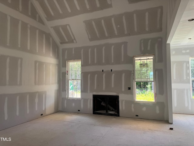 163 Batten Hill Ln, Selma, NC 27576 - unfurnished living room featuring a fireplace and vaulted ceiling