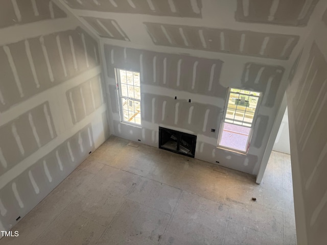 163 Batten Hill Ln, Selma, NC 27576 - unfurnished living room with a fireplace and plenty of natural light