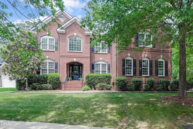 225 Norwalk St, Holly Springs, NC 27540 - view of front of home with brick siding and a front yard