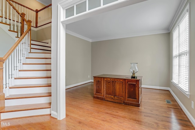 225 Norwalk St, Holly Springs, NC 27540 - stairs with plenty of natural light, crown molding, wood finished floors, and baseboards