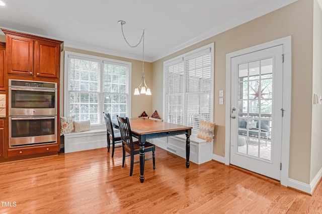 225 Norwalk St, Holly Springs, NC 27540 - dining room featuring light wood-type flooring, crown molding, and baseboards