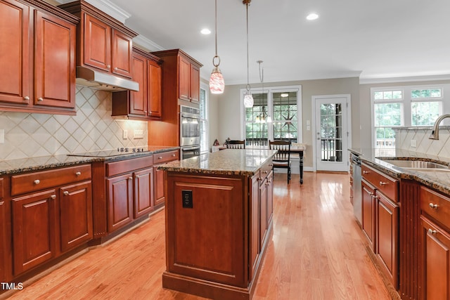 225 Norwalk St, Holly Springs, NC 27540 - kitchen featuring a sink, appliances with stainless steel finishes, backsplash, light wood finished floors, and crown molding