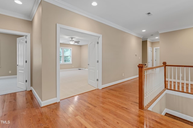 225 Norwalk St, Holly Springs, NC 27540 - hall featuring an upstairs landing, baseboards, crown molding, light wood-style flooring, and recessed lighting