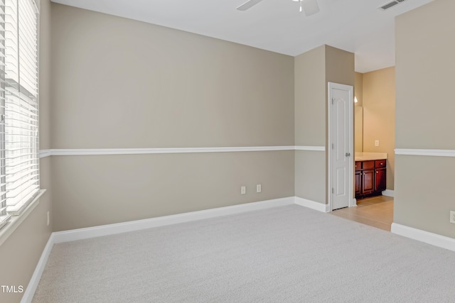 225 Norwalk St, Holly Springs, NC 27540 - spare room featuring light colored carpet, a ceiling fan, and baseboards