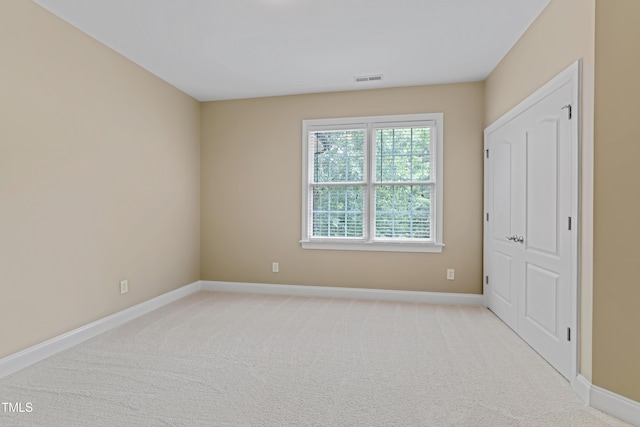 225 Norwalk St, Holly Springs, NC 27540 - unfurnished bedroom with baseboards and light carpet