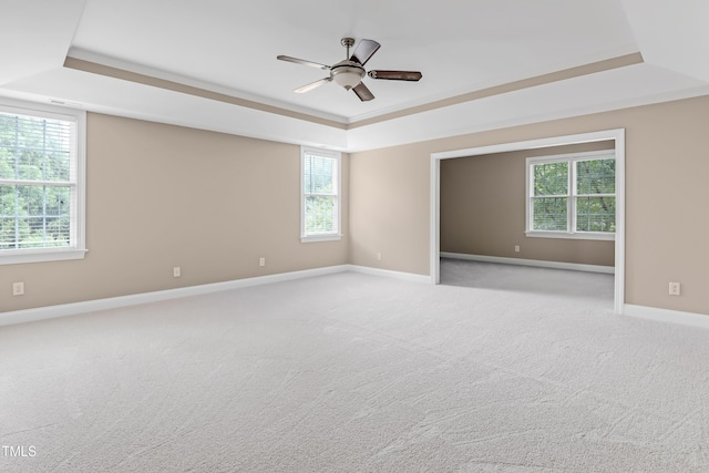 225 Norwalk St, Holly Springs, NC 27540 - spare room featuring a raised ceiling, baseboards, ceiling fan, and healthy amount of natural light