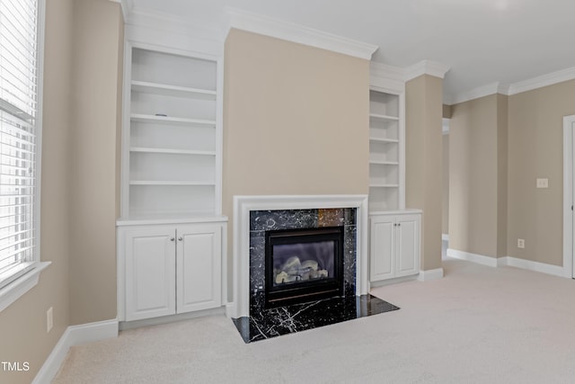 225 Norwalk St, Holly Springs, NC 27540 - unfurnished living room featuring carpet flooring, a high end fireplace, baseboards, built in shelves, and crown molding