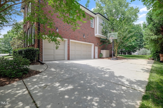 225 Norwalk St, Holly Springs, NC 27540 - view of property exterior with brick siding, driveway, and a garage
