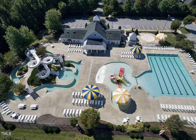 225 Norwalk St, Holly Springs, NC 27540 - drone / aerial view of a pool area and a tree filled landscape