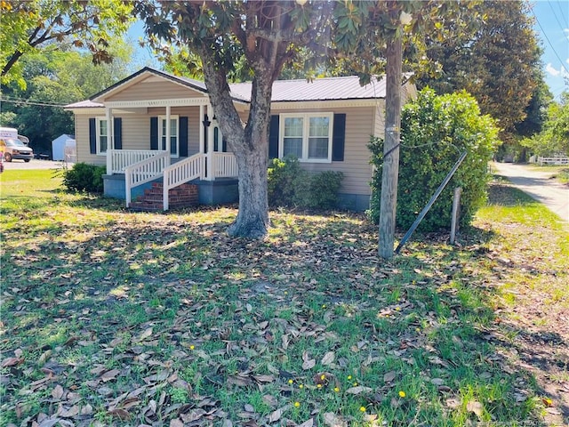 9881 Mccoll Rd, Laurinburg, NC 28352 - view of front of property with covered porch and metal roof