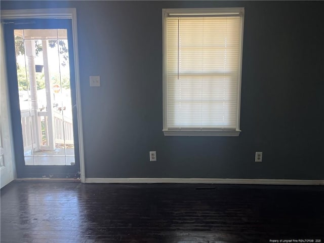 9881 Mccoll Rd, Laurinburg, NC 28352 - spare room with plenty of natural light, wood finished floors, and baseboards