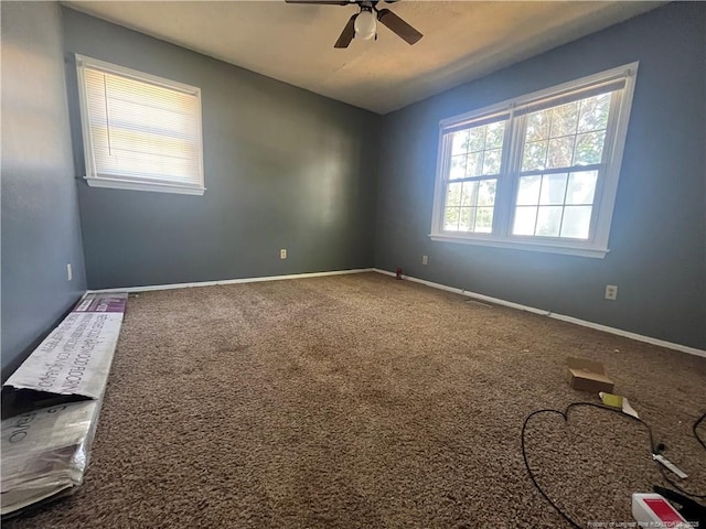 9881 Mccoll Rd, Laurinburg, NC 28352 - empty room featuring a ceiling fan, carpet, and baseboards