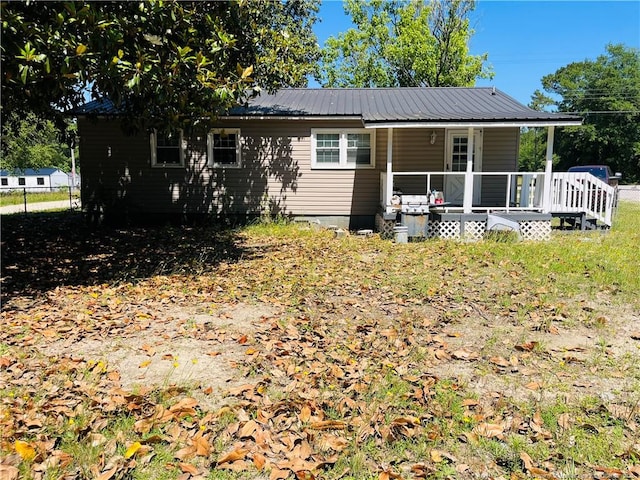 9881 Mccoll Rd, Laurinburg, NC 28352 - rear view of house featuring a porch and metal roof