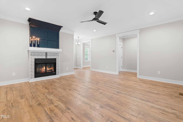 1004 Snow Peak Ct, Raleigh, NC 27603 - unfurnished living room with ornamental molding, ceiling fan, light wood-style floors, a lit fireplace, and recessed lighting
