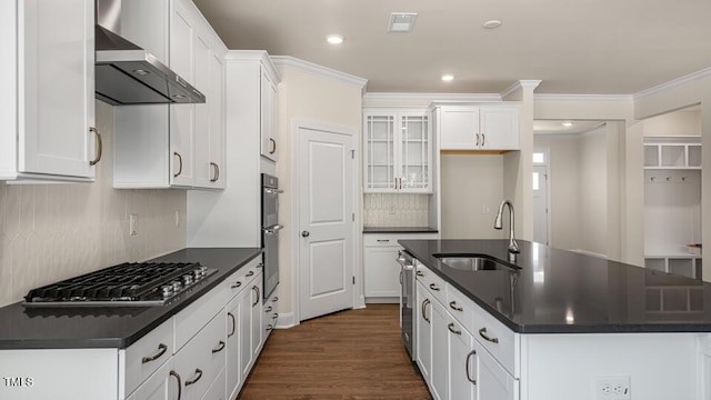 194 Gilmer St, Fuquay Varina, NC 27526 - kitchen featuring a sink, dark countertops, wall chimney exhaust hood, stainless steel appliances, and an island with sink