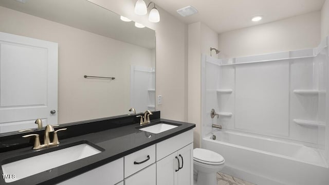 194 Gilmer St, Fuquay Varina, NC 27526 - full bathroom featuring toilet, double vanity, bathtub / shower combination, marble finish floors, and recessed lighting