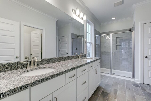 2309 Redbridge Ln, Apex, NC 27502 - bathroom featuring double vanity, a stall shower, ornamental molding, and recessed lighting