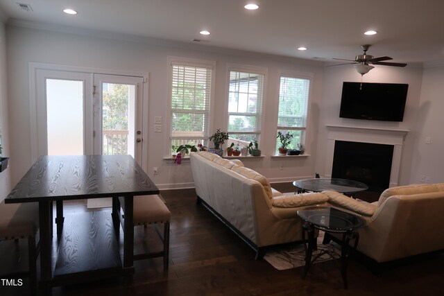 2309 Redbridge Ln, Apex, NC 27502 - living area featuring a fireplace, recessed lighting, dark wood-style flooring, crown molding, and ceiling fan