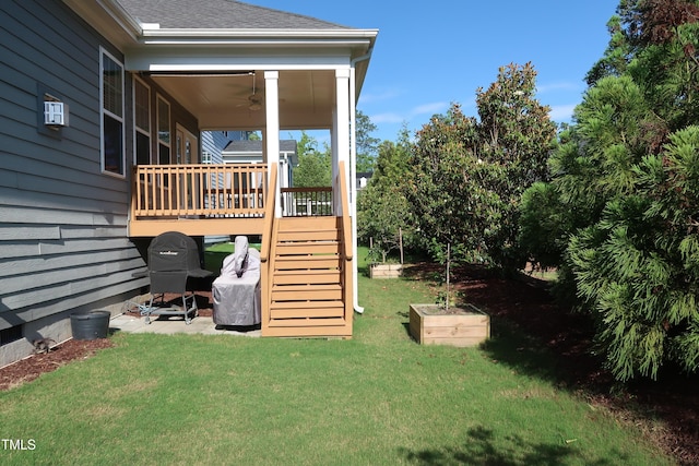 2309 Redbridge Ln, Apex, NC 27502 - view of green lawn with stairway, a ceiling fan, and a wooden deck
