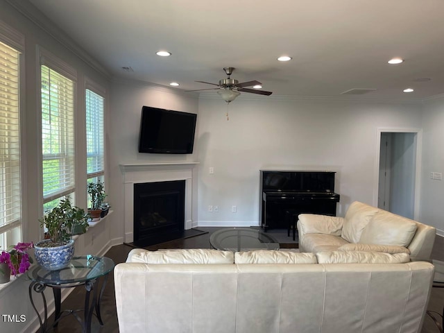 2309 Redbridge Ln, Apex, NC 27502 - living area with crown molding, ceiling fan, recessed lighting, and a fireplace