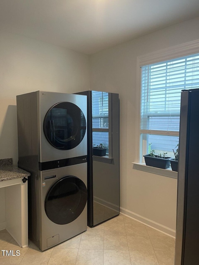2309 Redbridge Ln, Apex, NC 27502 - washroom with stacked washer and clothes dryer and light tile patterned floors
