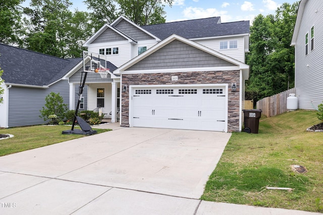 389 Whetstone Dr, Angier, NC 27501 - craftsman-style house featuring stone siding, a garage, and concrete driveway