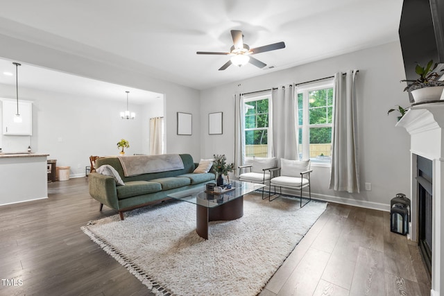 389 Whetstone Dr, Angier, NC 27501 - living area with dark wood finished floors, ceiling fan, a fireplace, and baseboards