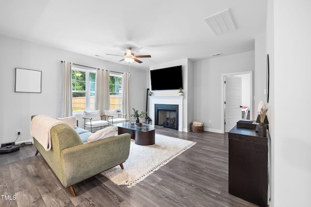 389 Whetstone Dr, Angier, NC 27501 - living room featuring a ceiling fan, dark wood finished floors, a fireplace, and baseboards