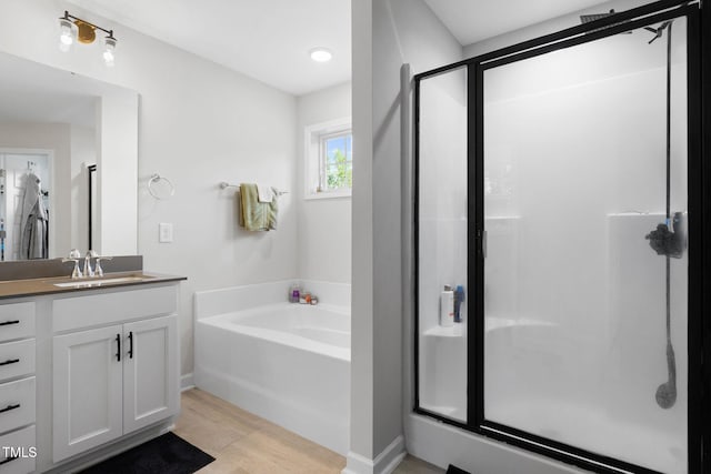 389 Whetstone Dr, Angier, NC 27501 - bathroom featuring a bath, vanity, a stall shower, and wood finished floors