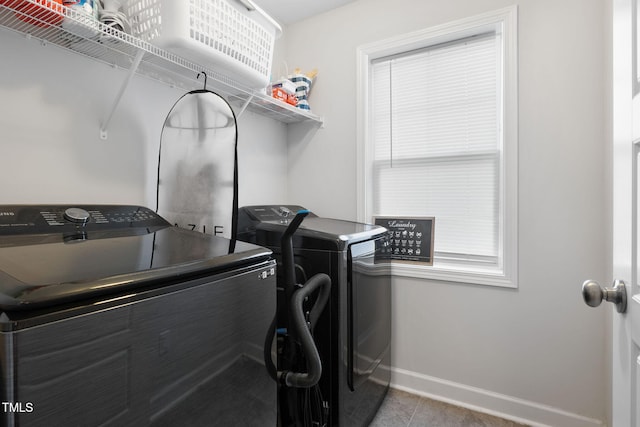 389 Whetstone Dr, Angier, NC 27501 - laundry area featuring washing machine and clothes dryer, baseboards, and tile patterned floors