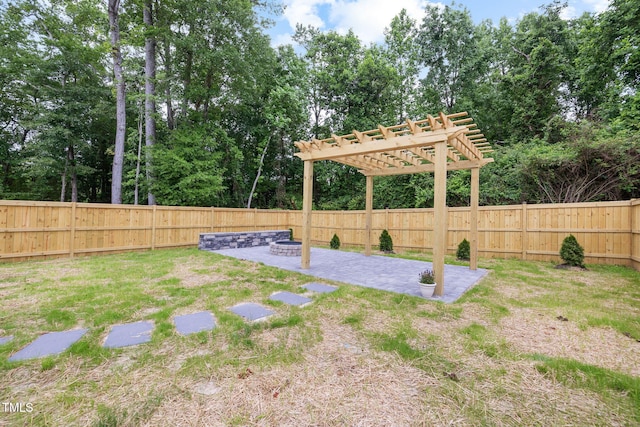 389 Whetstone Dr, Angier, NC 27501 - fenced backyard with a patio area, a pergola, and view of wooded area