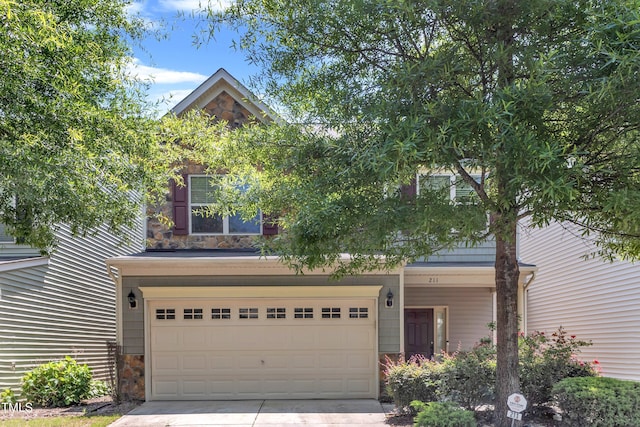 211 Westgrove Ct, Durham, NC 27703 - view of front of home featuring stone siding, driveway, and an attached garage