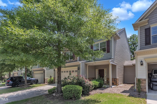 211 Westgrove Ct, Durham, NC 27703 - view of front of house featuring stone siding, a garage, and concrete driveway
