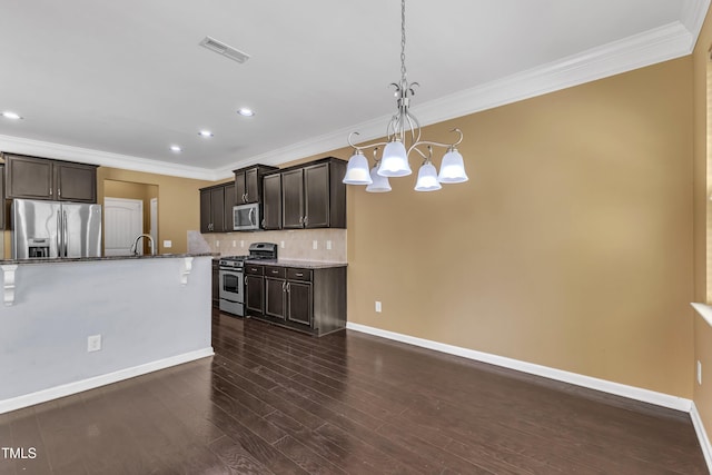 211 Westgrove Ct, Durham, NC 27703 - kitchen with stainless steel appliances, a chandelier, ornamental molding, backsplash, and baseboards