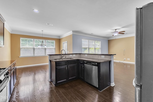 211 Westgrove Ct, Durham, NC 27703 - kitchen featuring stainless steel appliances, a sink, baseboards, crown molding, and dark wood-style flooring
