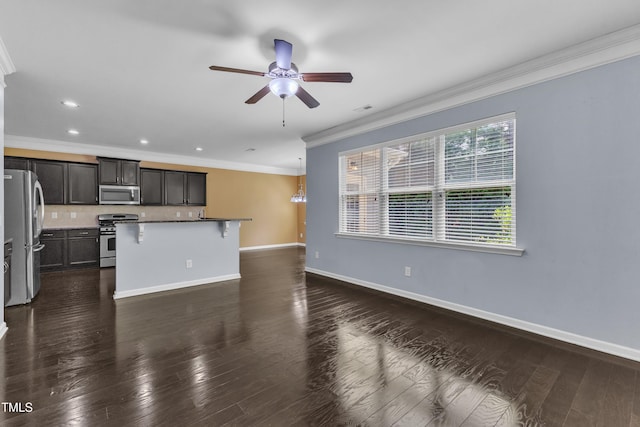 211 Westgrove Ct, Durham, NC 27703 - kitchen featuring stainless steel appliances, ornamental molding, ceiling fan, tasteful backsplash, and a kitchen breakfast bar
