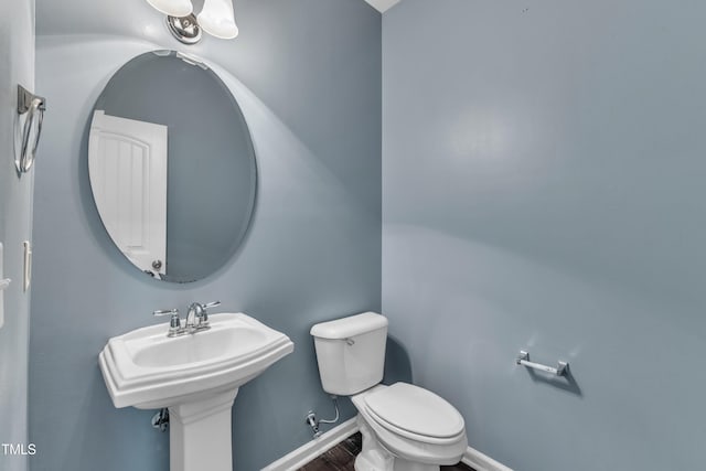 211 Westgrove Ct, Durham, NC 27703 - half bath with toilet, baseboards, and wood finished floors