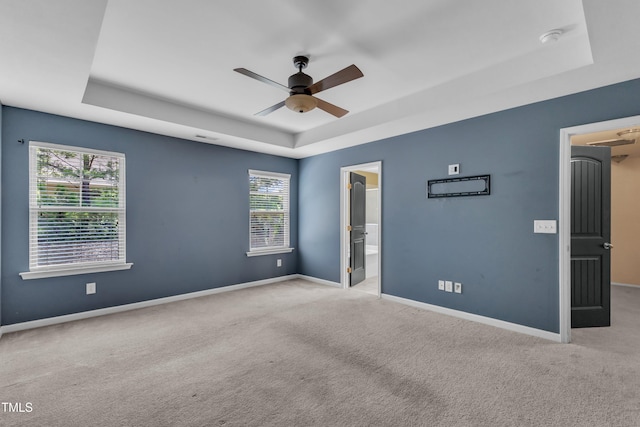 211 Westgrove Ct, Durham, NC 27703 - spare room with a raised ceiling, carpet flooring, a ceiling fan, and baseboards