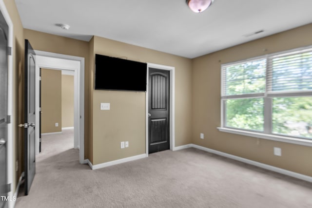 211 Westgrove Ct, Durham, NC 27703 - unfurnished bedroom featuring light colored carpet, baseboards, and a closet
