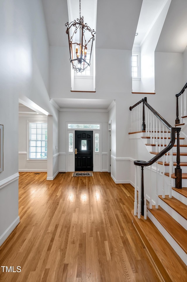 100 Sundance Pl, Chapel Hill, NC 27514 - foyer featuring a towering ceiling, a chandelier, wood finished floors, and stairs