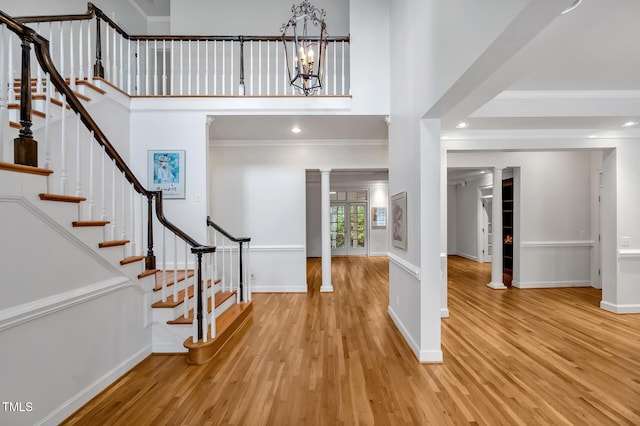 100 Sundance Pl, Chapel Hill, NC 27514 - entryway featuring wood finished floors, crown molding, decorative columns, a chandelier, and stairs