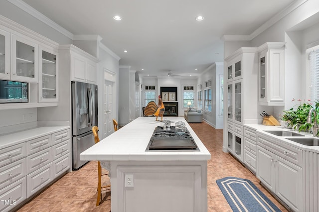 100 Sundance Pl, Chapel Hill, NC 27514 - kitchen with appliances with stainless steel finishes, recessed lighting, white cabinetry, ceiling fan, and a center island