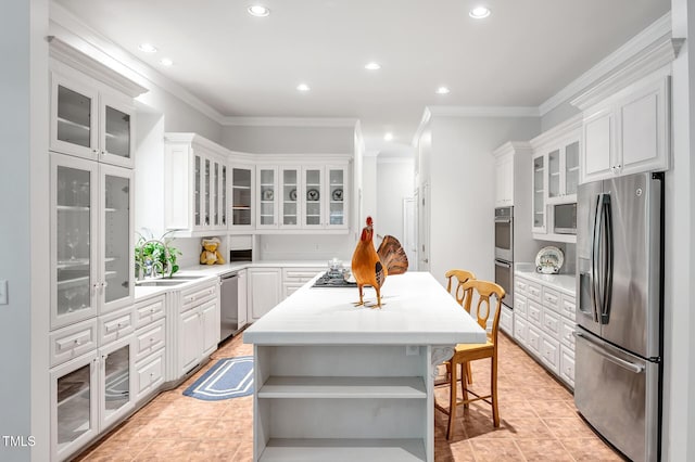 100 Sundance Pl, Chapel Hill, NC 27514 - kitchen featuring stainless steel appliances, a kitchen island, crown molding, light countertops, and recessed lighting