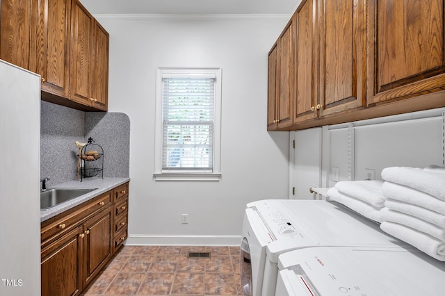 100 Sundance Pl, Chapel Hill, NC 27514 - laundry room with cabinet space, ornamental molding, and separate washer and dryer