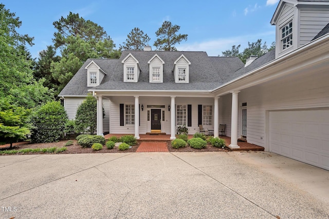 100 Sundance Pl, Chapel Hill, NC 27514 - cape cod house featuring a porch, concrete driveway, roof with shingles, a chimney, and a garage