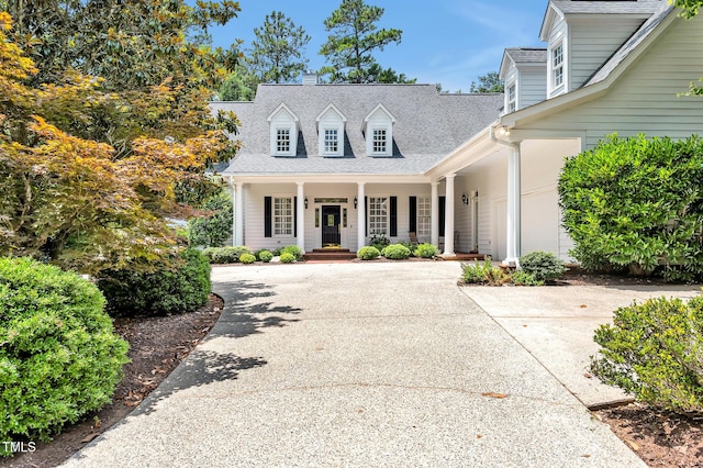 100 Sundance Pl, Chapel Hill, NC 27514 - new england style home with covered porch, roof with shingles, and concrete driveway