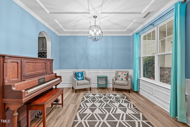 1939 Mostyn Ln, Apex, NC 27502 - sitting room with light wood finished floors, ornamental molding, a chandelier, and a wainscoted wall
